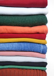 A Close Up of Folded Clothing Items of Many Different Colors